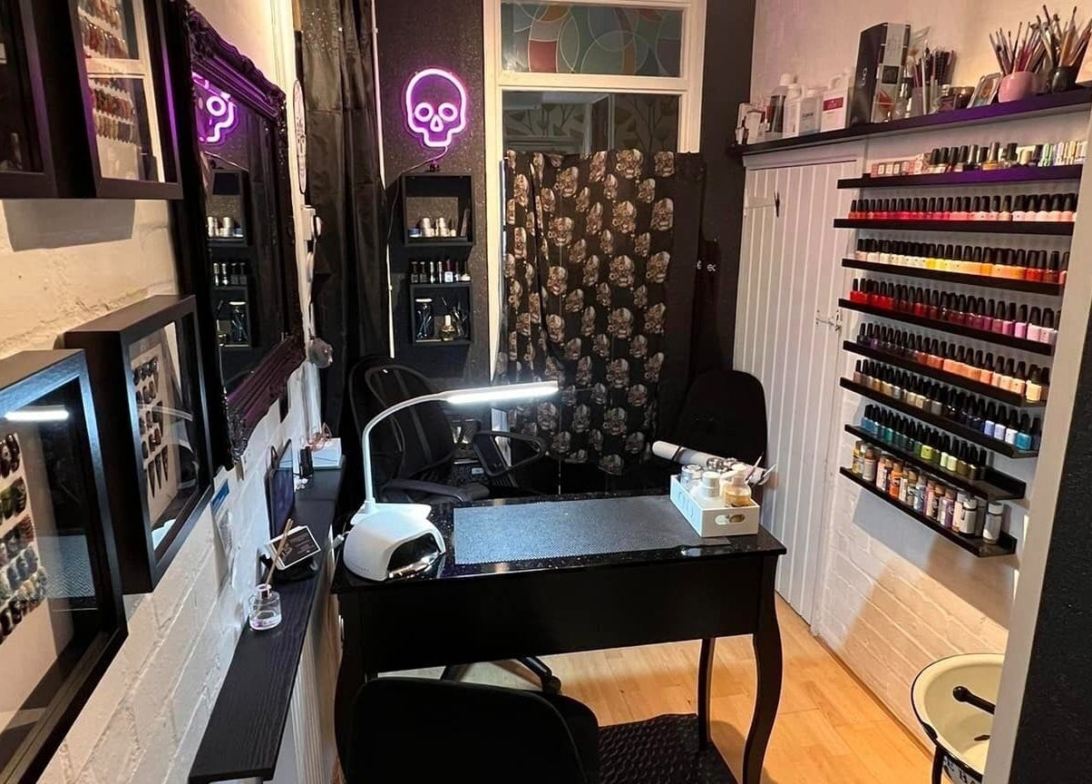 Cozy nail salon interior at Got Nails, Harlow, England, GB with colorful polish display and sleek manicure station.