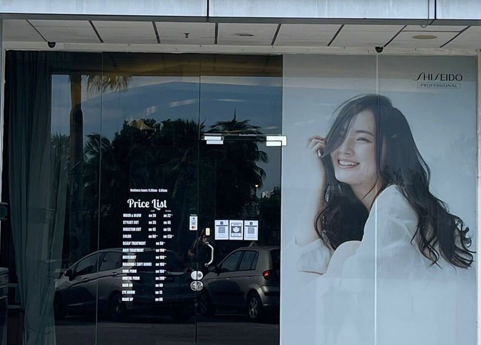 Front view of Fortune Hair Studio in Bayan Lepas, Pulau Pinang, MY with modern glass facade and promotional poster.