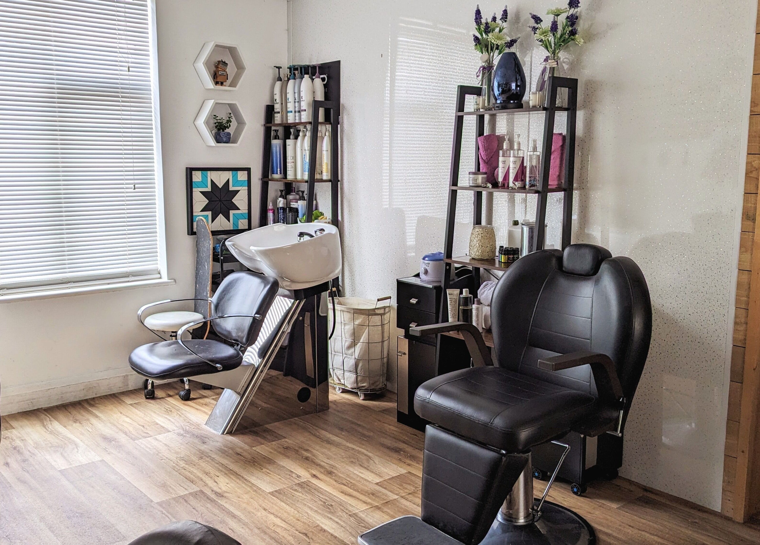 Modern salon interior at Pin and Pose Salon, Plymouth, England, GB with sleek chairs and stylish decor.