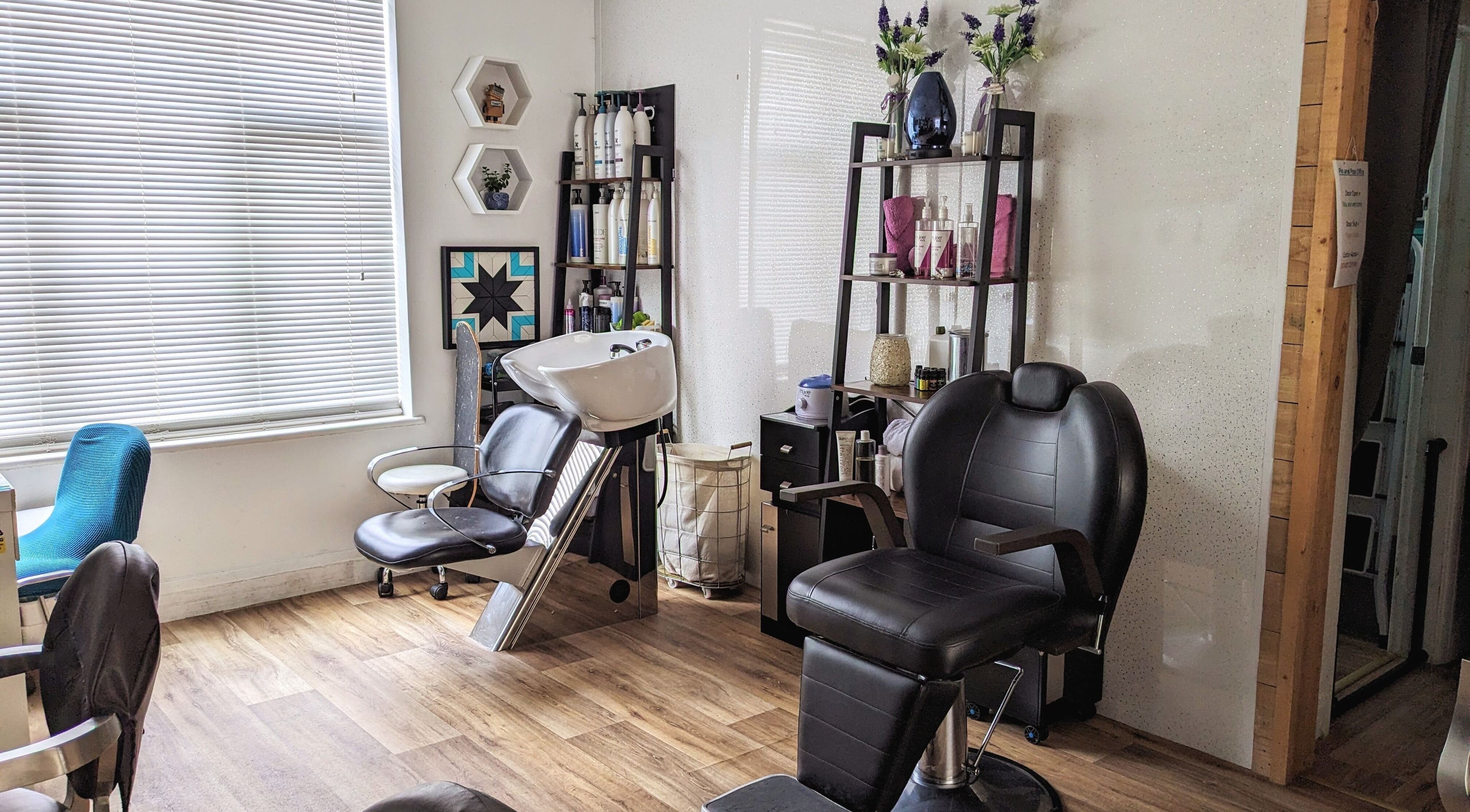 Modern salon interior at Pin and Pose Salon, Plymouth, England, GB with sleek chairs and stylish decor.