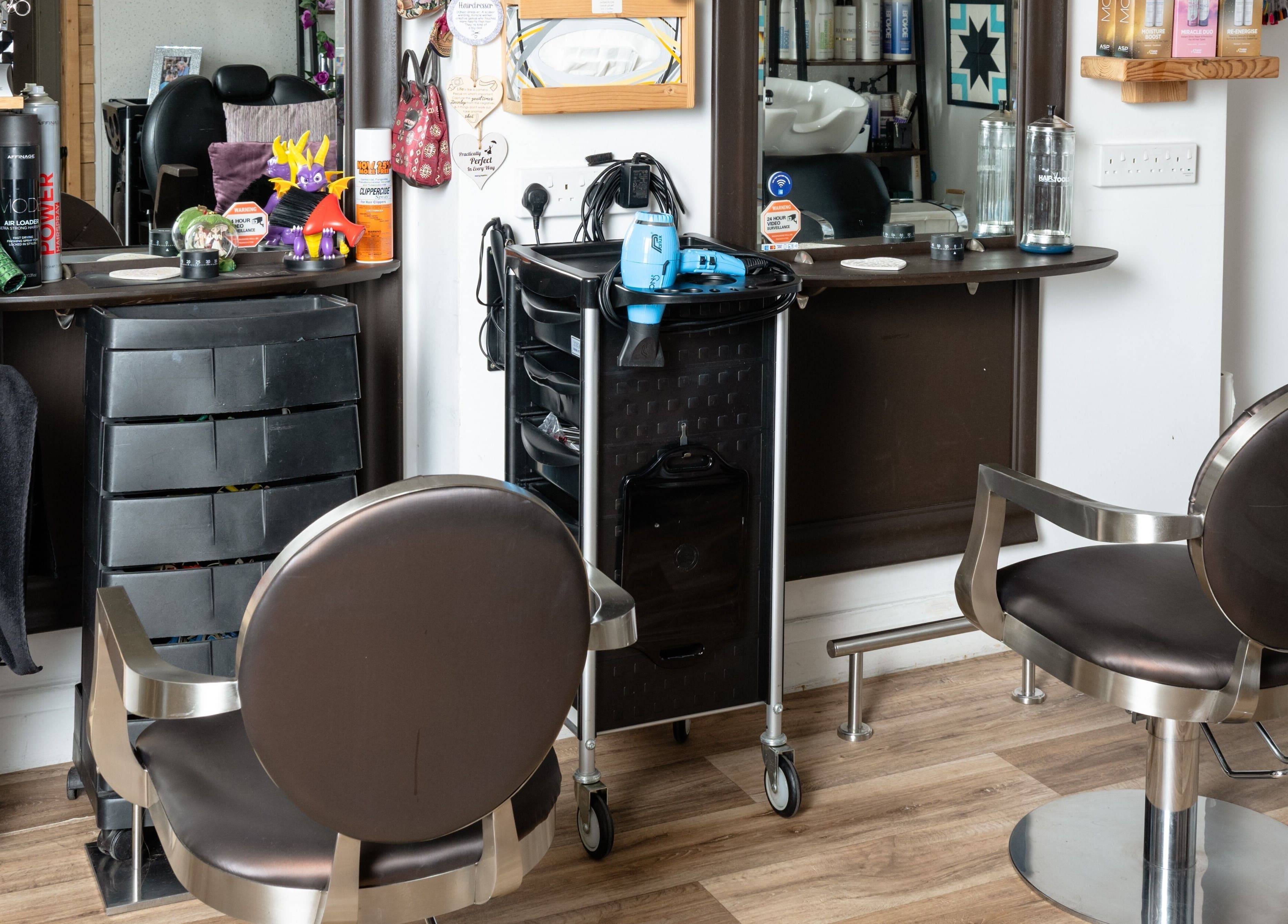 Modern styling station at Pin and Pose Salon in Plymouth, England, GB. Elegant chairs and sleek hair tools.