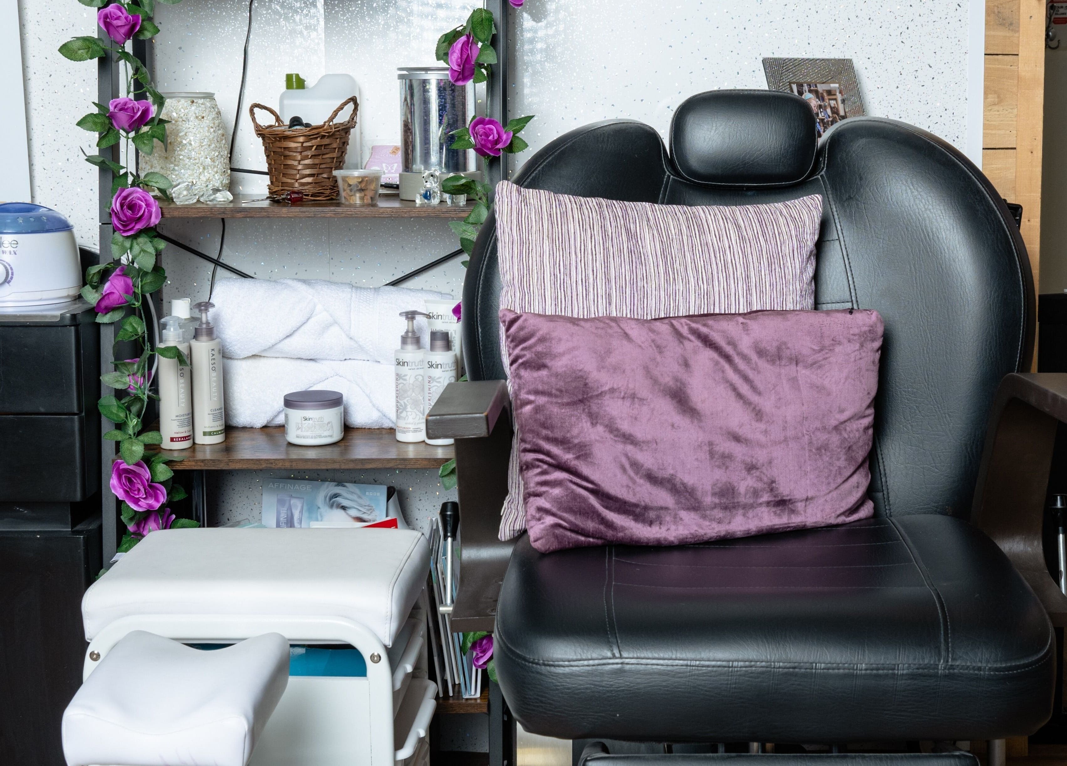 Relaxing treatment chair in Pin and Pose Salon, Plymouth, England, GB, with plush pillows and violet accents.