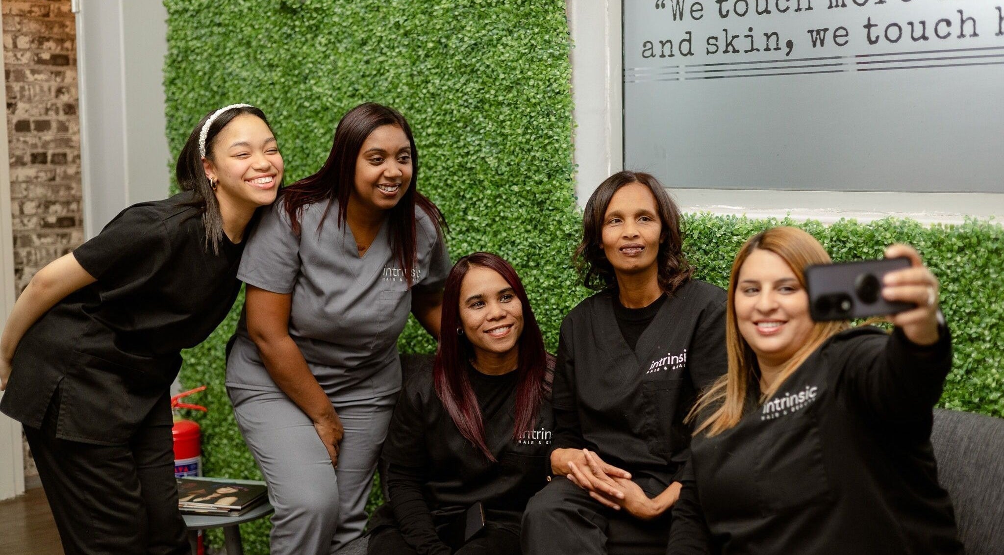 Team at Intrinsic Hair & Beauty Cape Town, Western Cape, ZA smiling and taking a selfie.