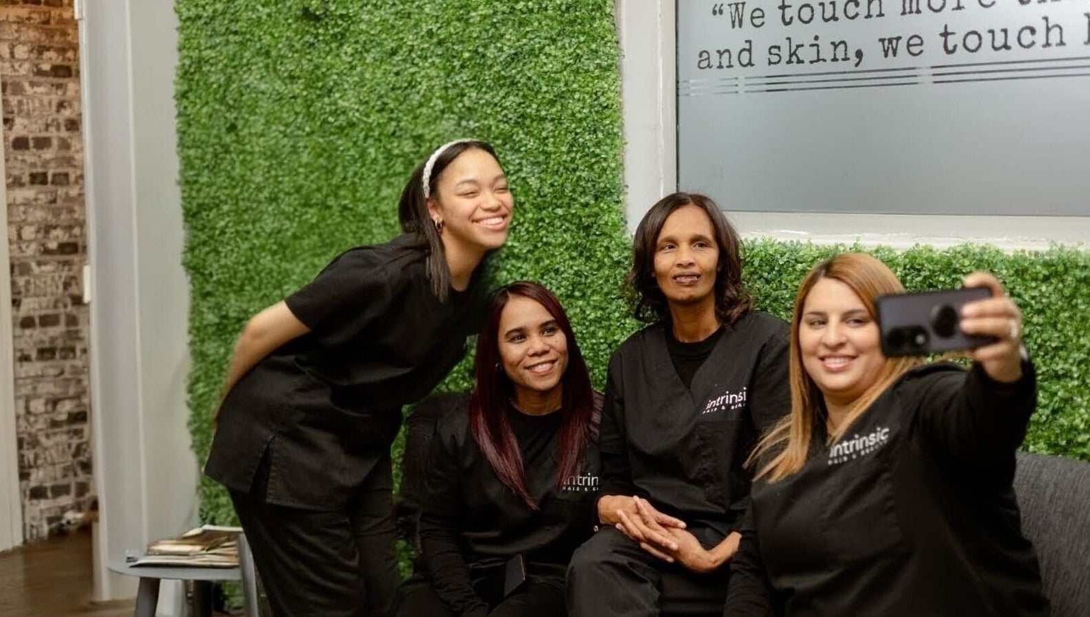 Team at Intrinsic Hair & Beauty, Cape Town, Western Cape, ZA, captures a joyful selfie in the salon.