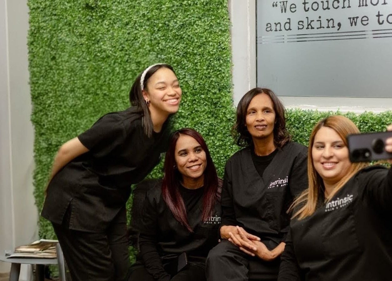 Team at Intrinsic Hair & Beauty, Cape Town, Western Cape, ZA, captures a joyful selfie in the salon.