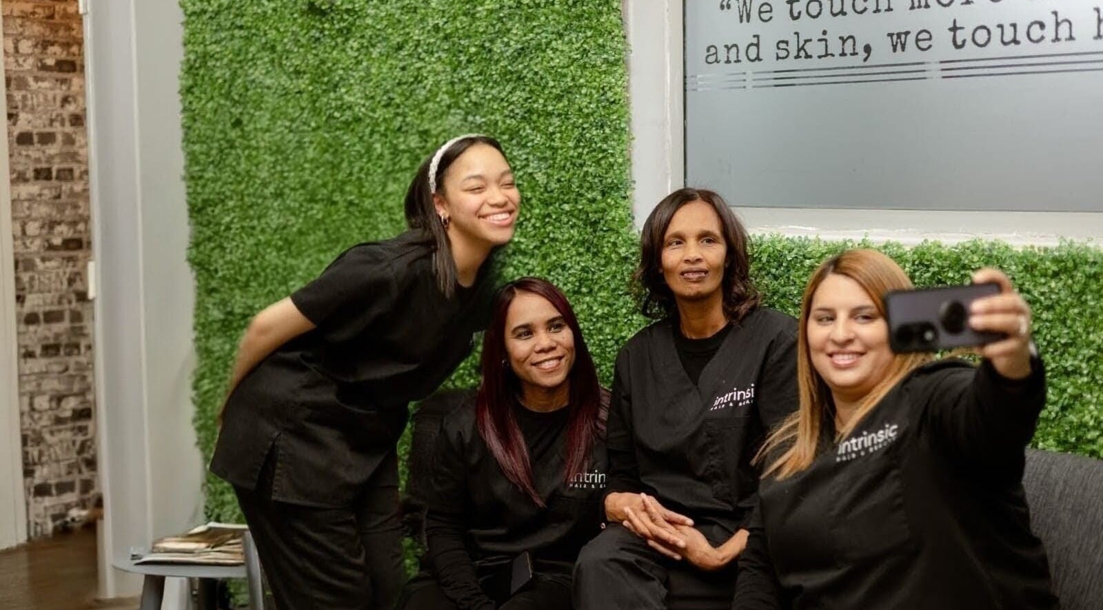Team at Intrinsic Hair & Beauty, Cape Town, Western Cape, ZA, captures a joyful selfie in the salon.