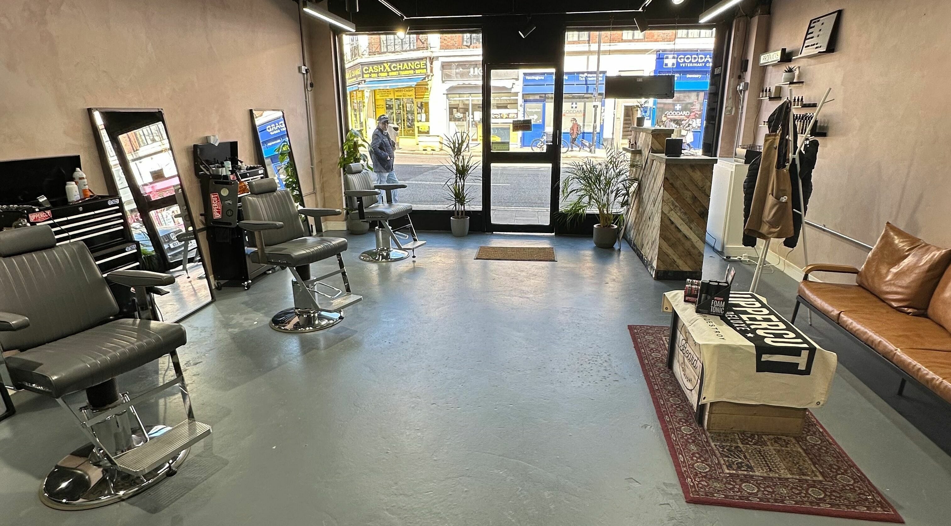Interior of London Beard Co Barbershop Hackney, featuring chic chairs and modern decor in London, England, GB.