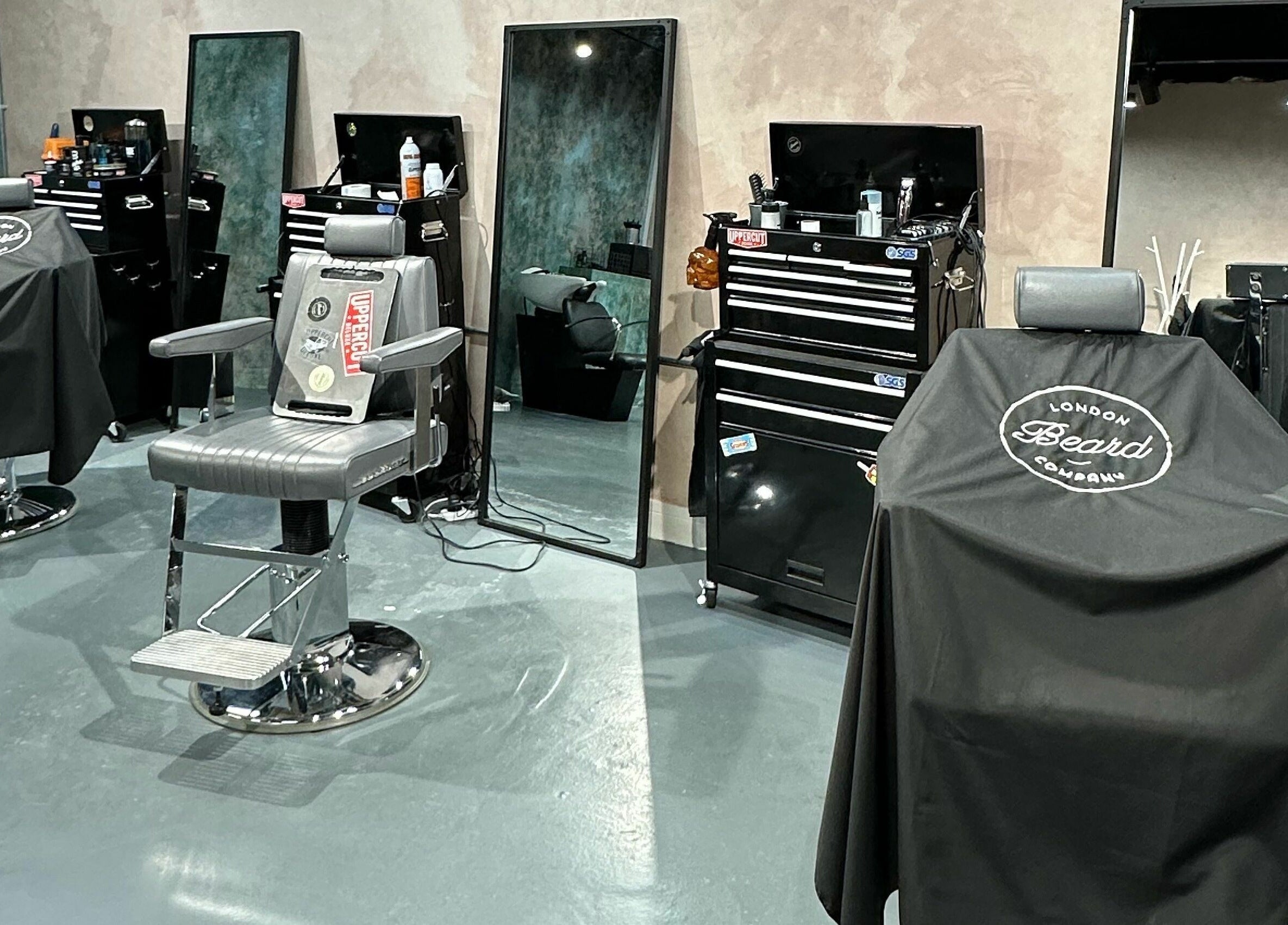 Interior of London Beard Co Barbershop Hackney in London, England, GB featuring stylish barber chairs and mirrors.