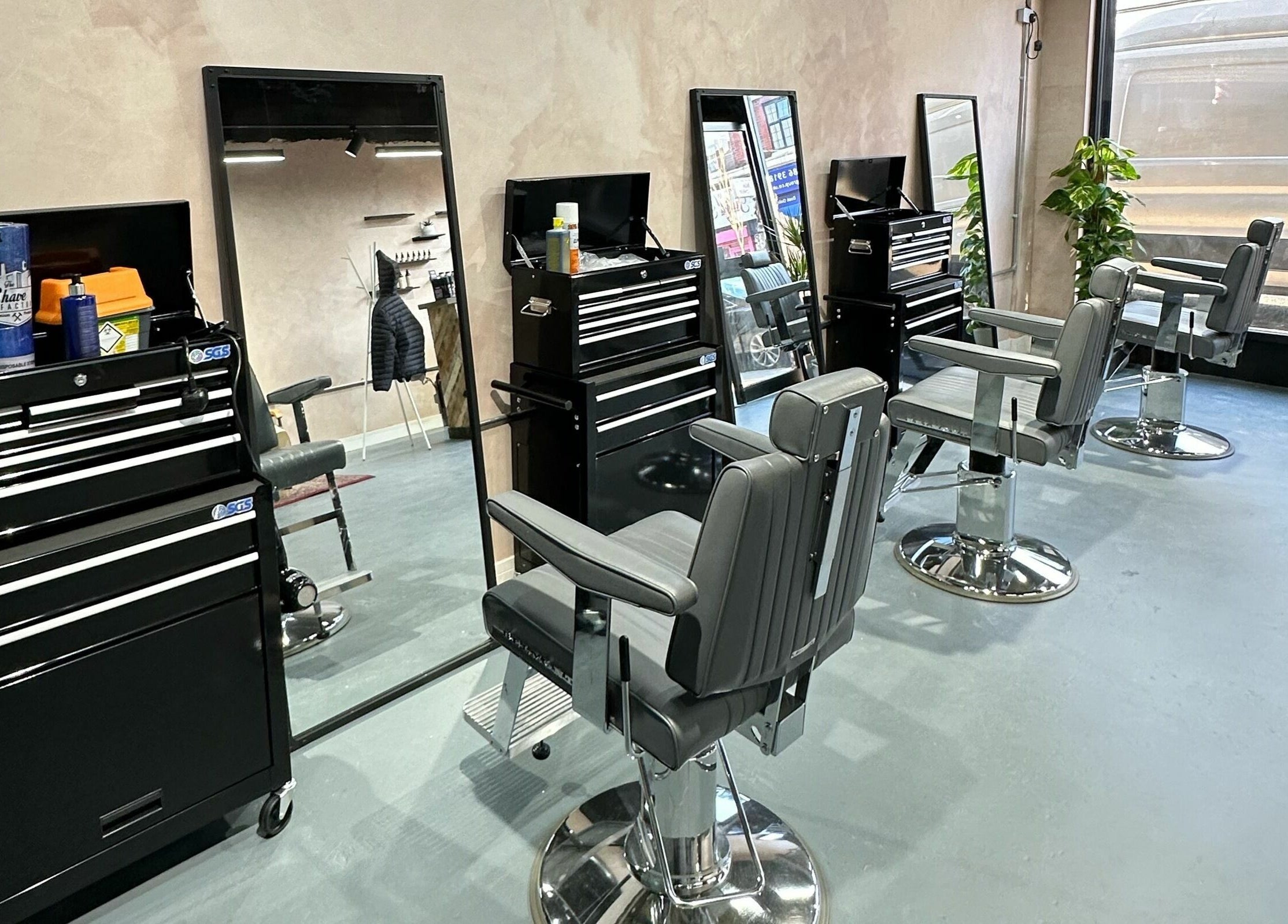 Modern barber chairs inside London Beard Co Barbershop Hackney, located in London, England, GB.