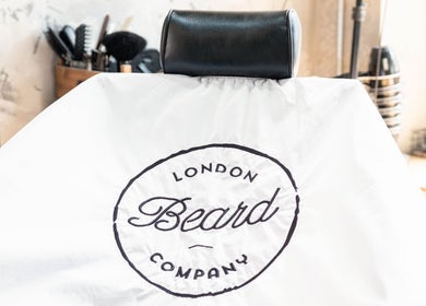 Barber chair at London Beard Co Barbershop Dalston, London, England, GB with logo displayed.
