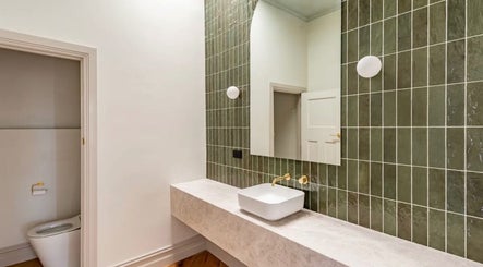 Modern bathroom with green tiles at S KIN CO Liebe Wellness - Mornington, Mornington, Victoria, AU.