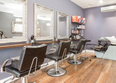 Elegant salon interior with styling chairs at Divine London Clinic, Northwood, England, GB.