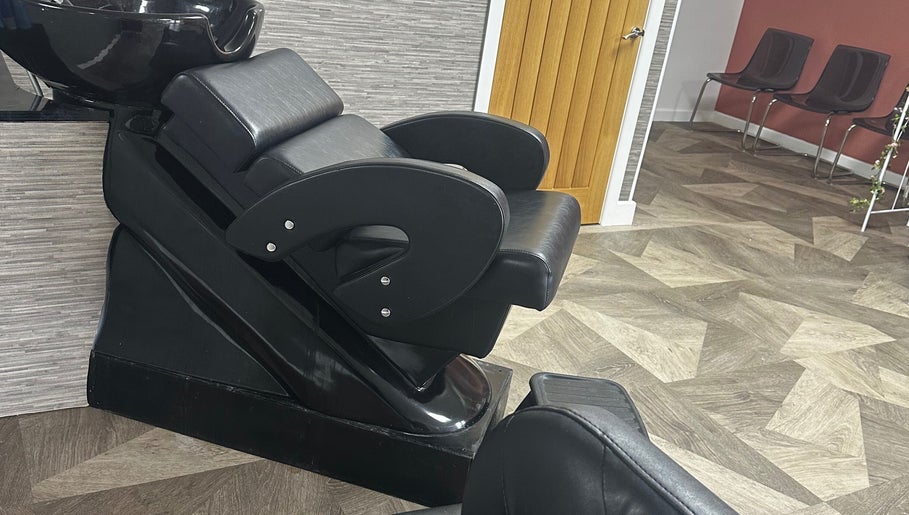 Modern hair wash station at MKT Hair & Beauty in Weymouth, England, GB, featuring sleek black seating.