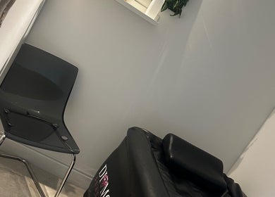 Relaxing seating at MKT Hair & Beauty in Weymouth, England, GB. Modern chair and styling equipment in view.