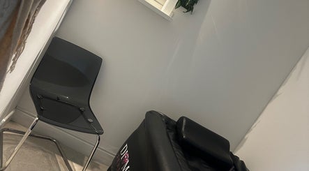 Relaxing seating at MKT Hair & Beauty in Weymouth, England, GB. Modern chair and styling equipment in view.
