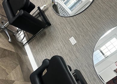 MKT Hair & Beauty salon in Weymouth, England, GB features stylish black chairs and modern mirrors.