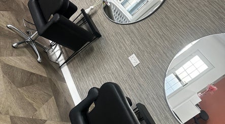 MKT Hair & Beauty salon in Weymouth, England, GB features stylish black chairs and modern mirrors.