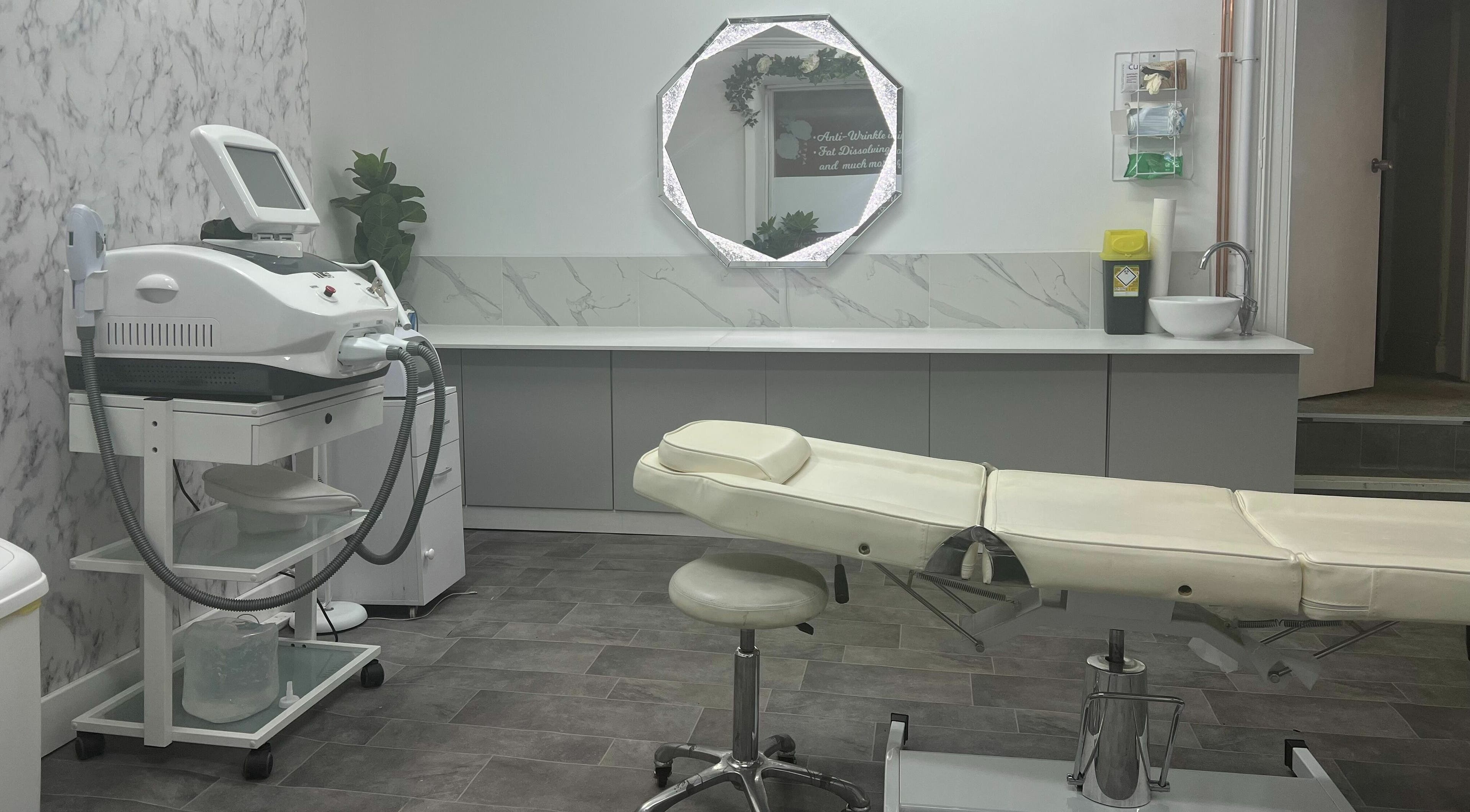 Modern treatment room at Elle Belle's, Dereham, England, GB, featuring a sleek spa bed and high-tech equipment.