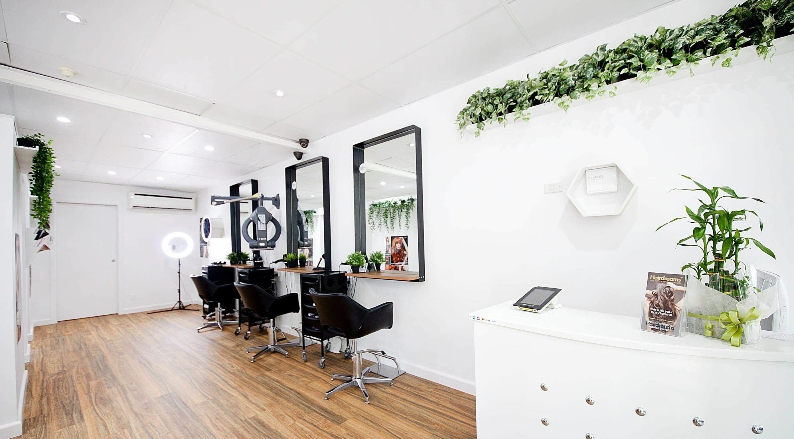 Modern salon at Juliana Hairstylist & Beautician in Dee Why, New South Wales, AU with sleek design and plants.
