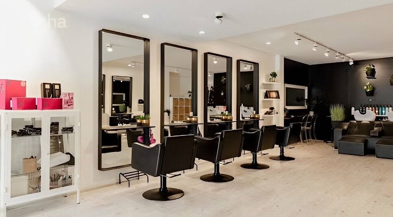 Chic interior of Louise Richmond Hair Design in Sydney, New South Wales, AU featuring modern salon chairs and mirrors.