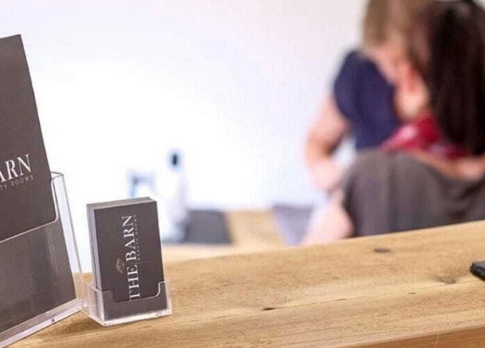 Reception area at The Barn Beauty Rooms, Norwich, England, with branded literature displayed.