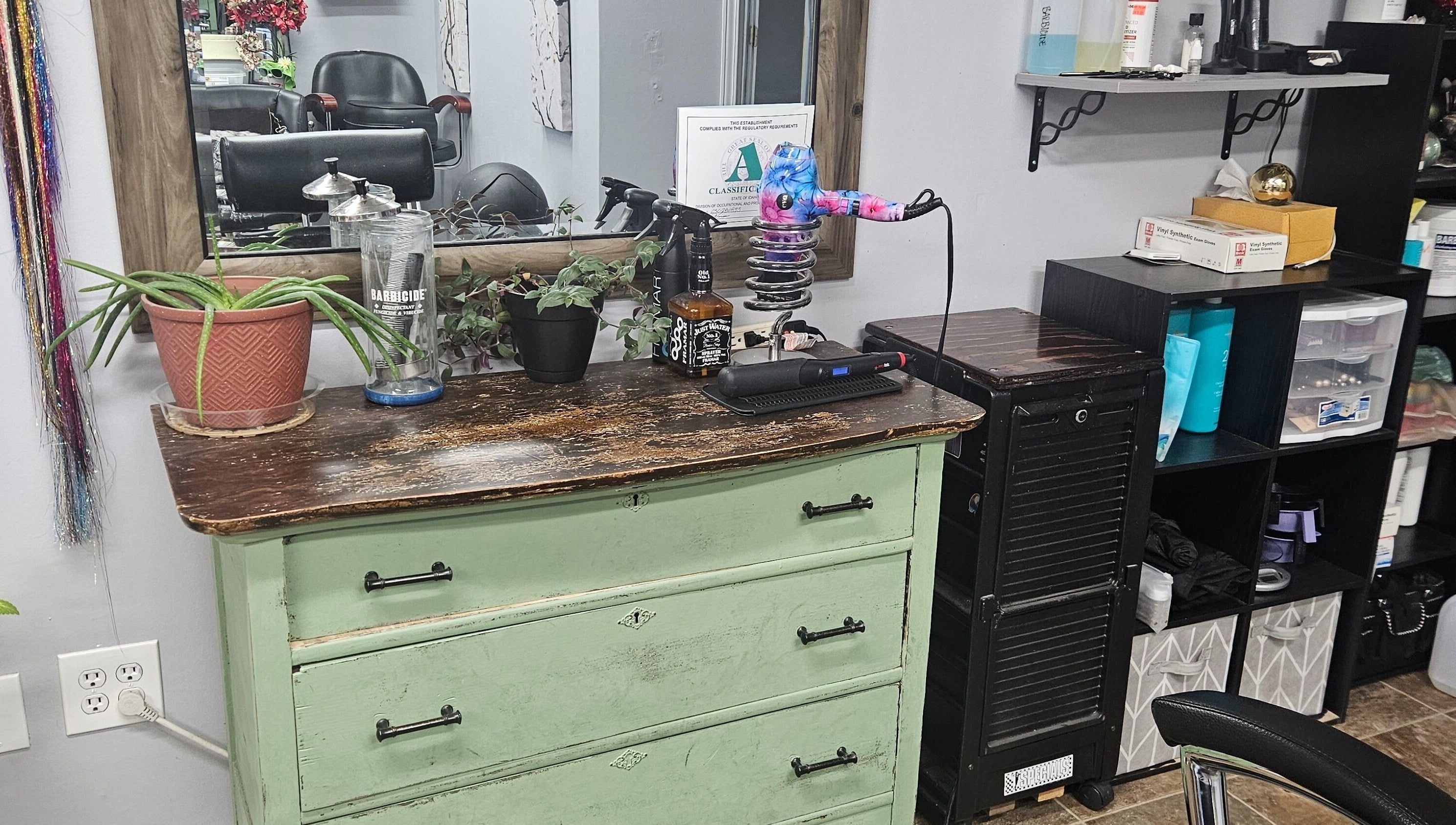 Rustic salon station at Victoria Farris, Lewiston, Idaho, US with stylish decor, plants, and hair tools.