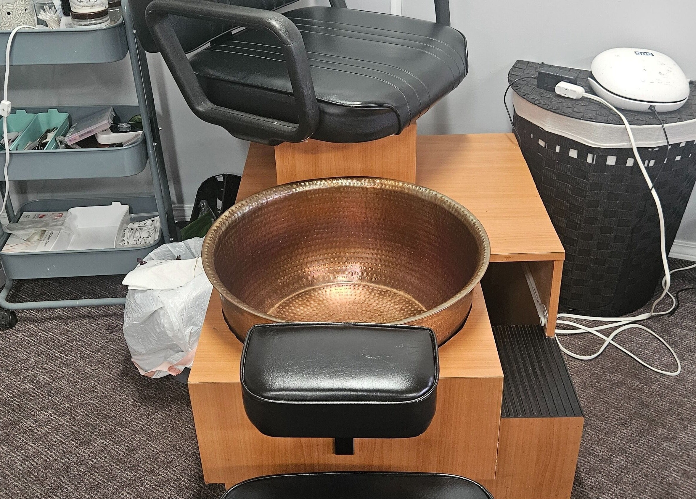 Pedicure station at Victoria Farris, Lewiston, Idaho, US features a luxurious copper foot basin and cozy chair.