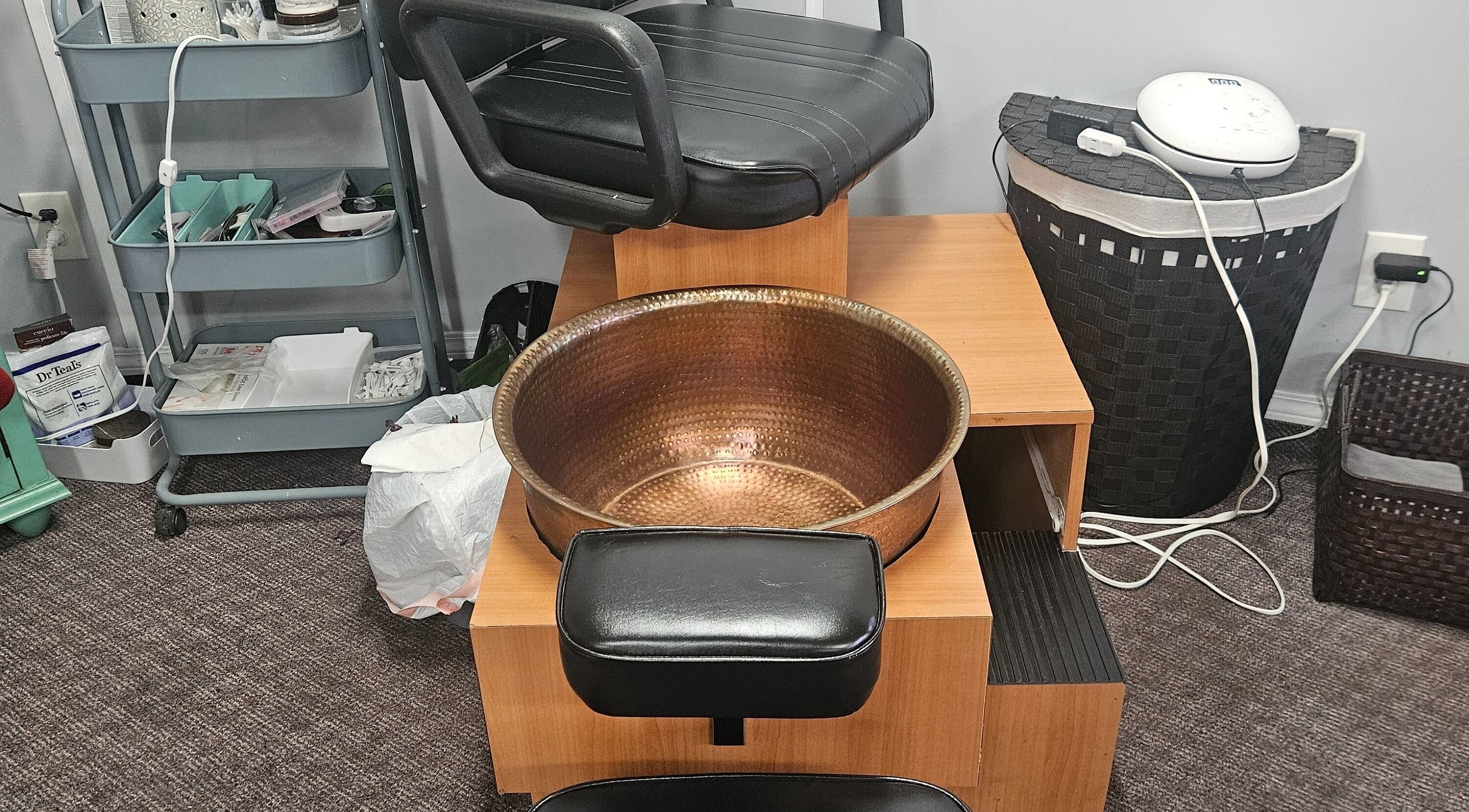 Pedicure station at Victoria Farris, Lewiston, Idaho, US features a luxurious copper foot basin and cozy chair.