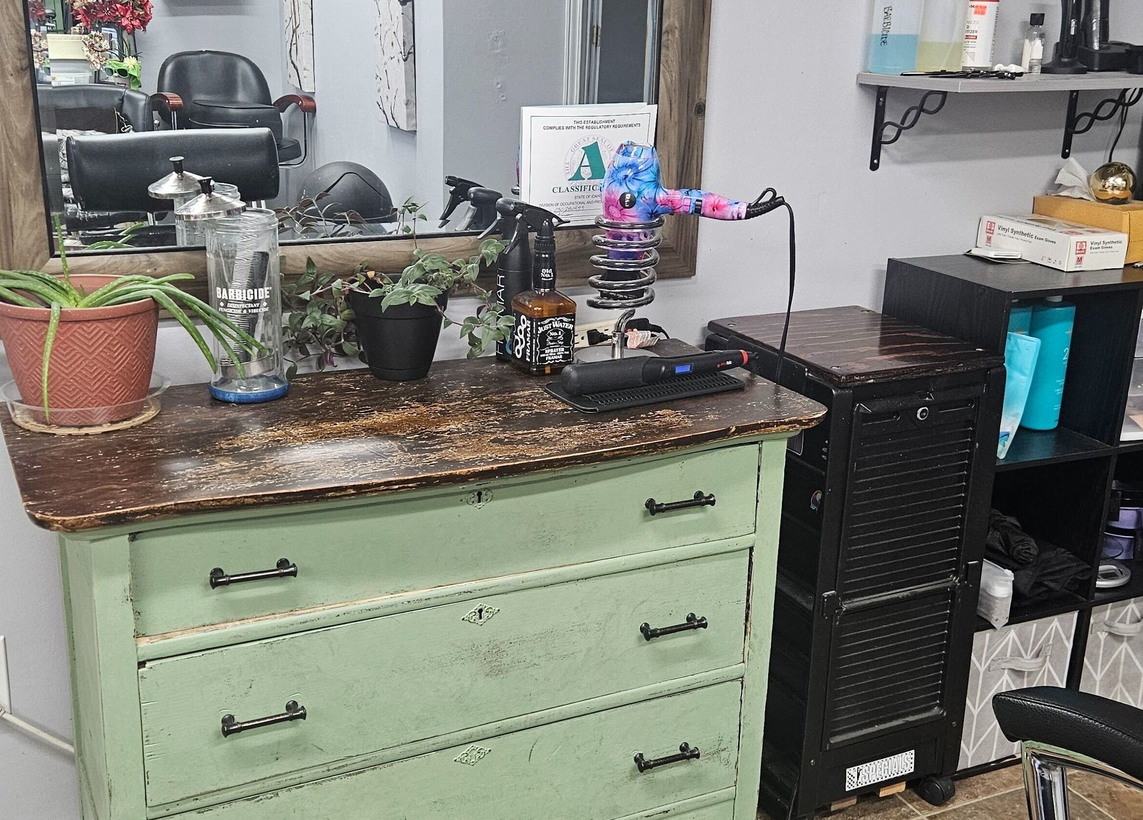 Charming salon station at Victoria Farris in Lewiston, Idaho, US with vintage dresser and hairstyling tools.