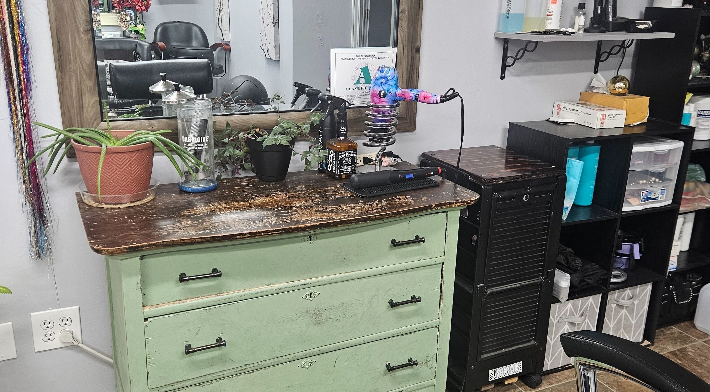 Charming salon station at Victoria Farris in Lewiston, Idaho, US with vintage dresser and hairstyling tools.