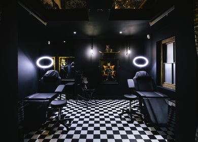 Inside BarberSmiths Tattoo Studio, London, England, GB. Modern tattoo chairs under soft lighting in a chic setting.