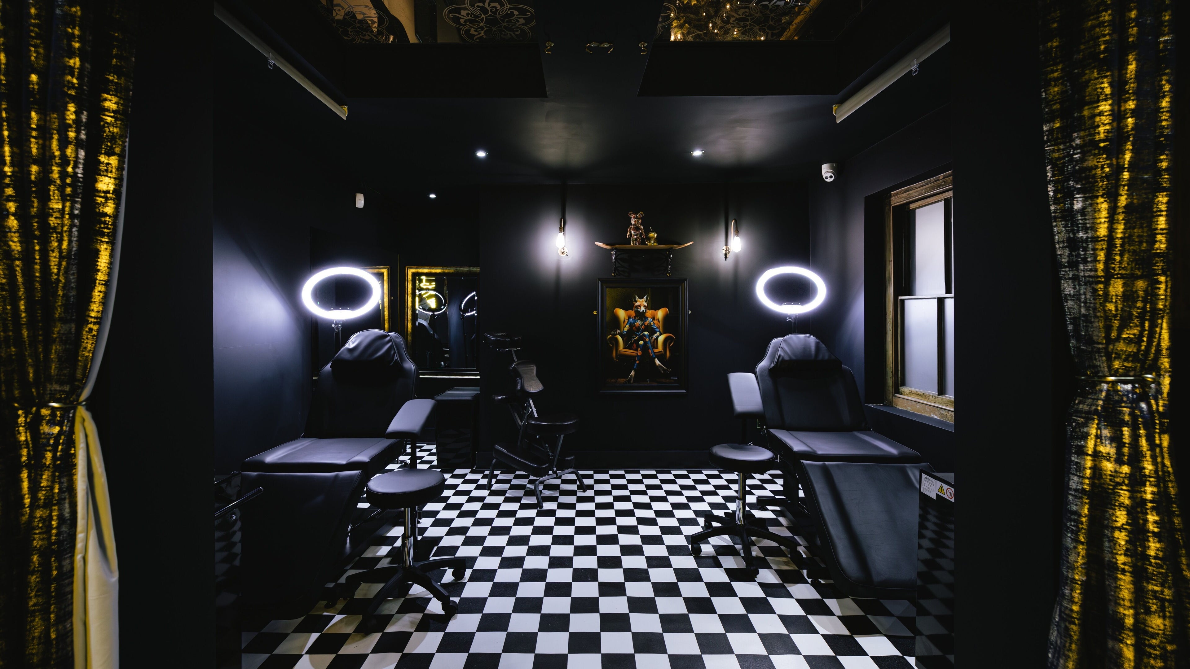 Inside BarberSmiths Tattoo Studio, London, England, GB. Modern tattoo chairs under soft lighting in a chic setting.