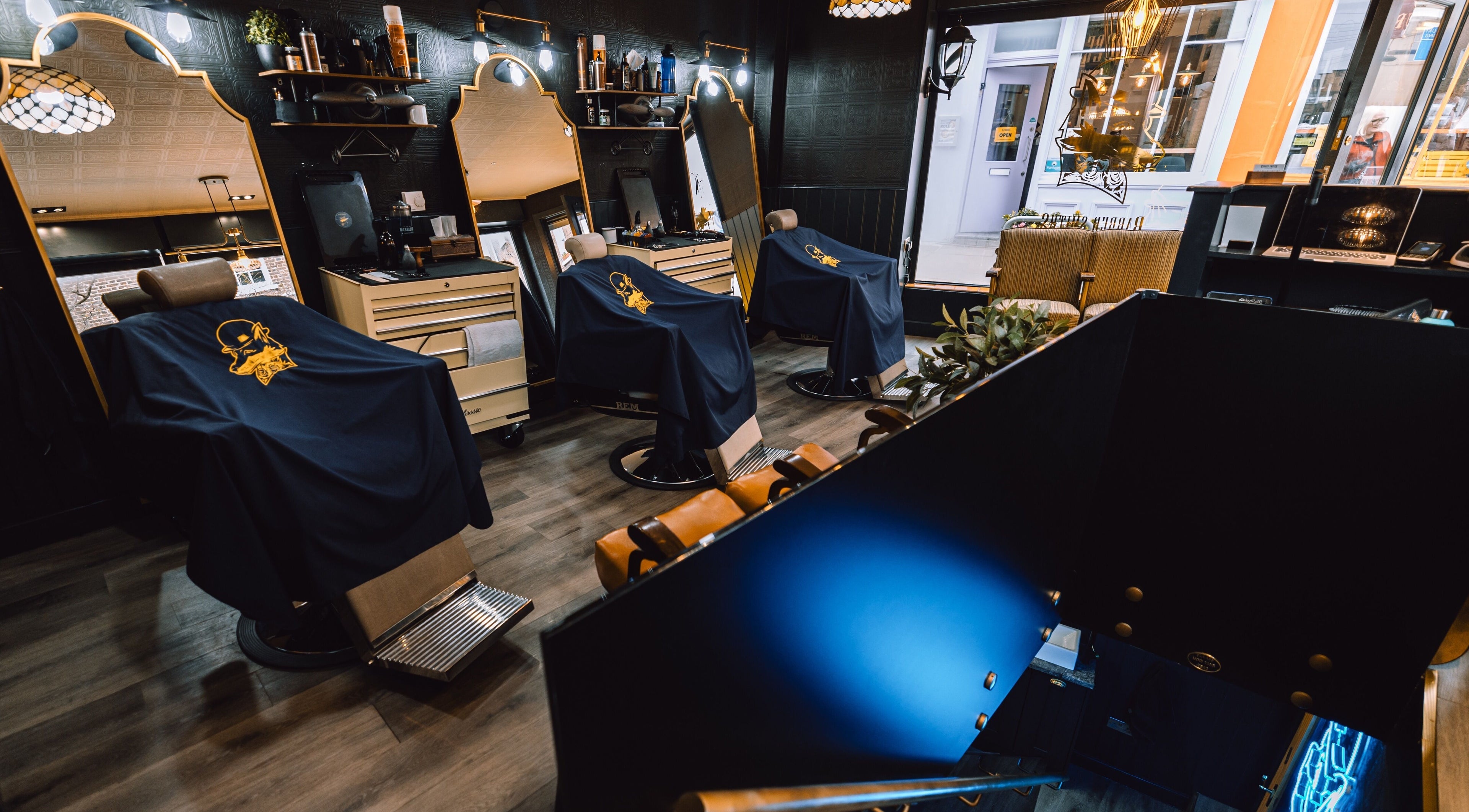 Stylish interior of BarberSmiths Islington in London, England, GB with modern barber chairs and mirrors.