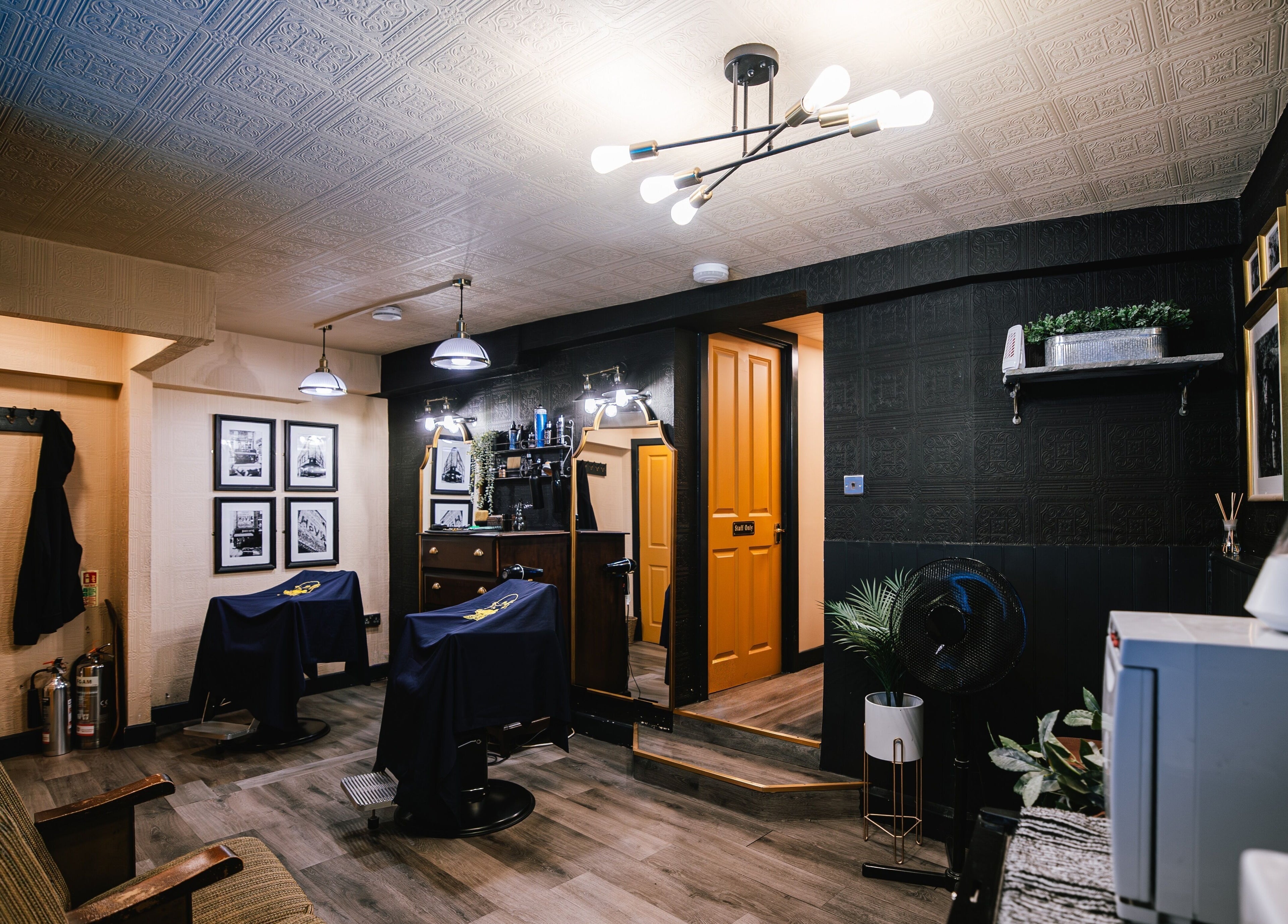 Cozy vintage interior of BarberSmiths Islington, London, England, GB with stylish decor and elegant lighting.