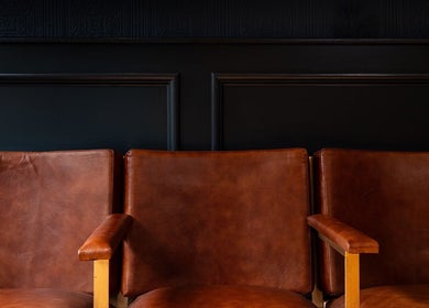 Warm brown leather chairs at BarberSmiths Notting Hill in London, England, GB, offer a stylish waiting area.