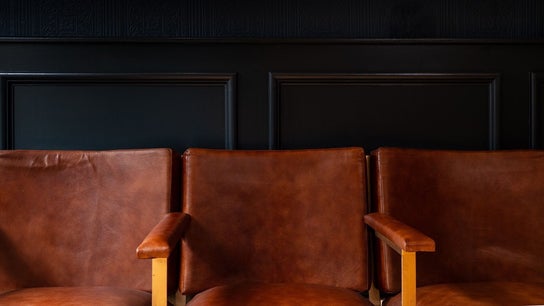 Warm brown leather chairs at BarberSmiths Notting Hill in London, England, GB, offer a stylish waiting area.