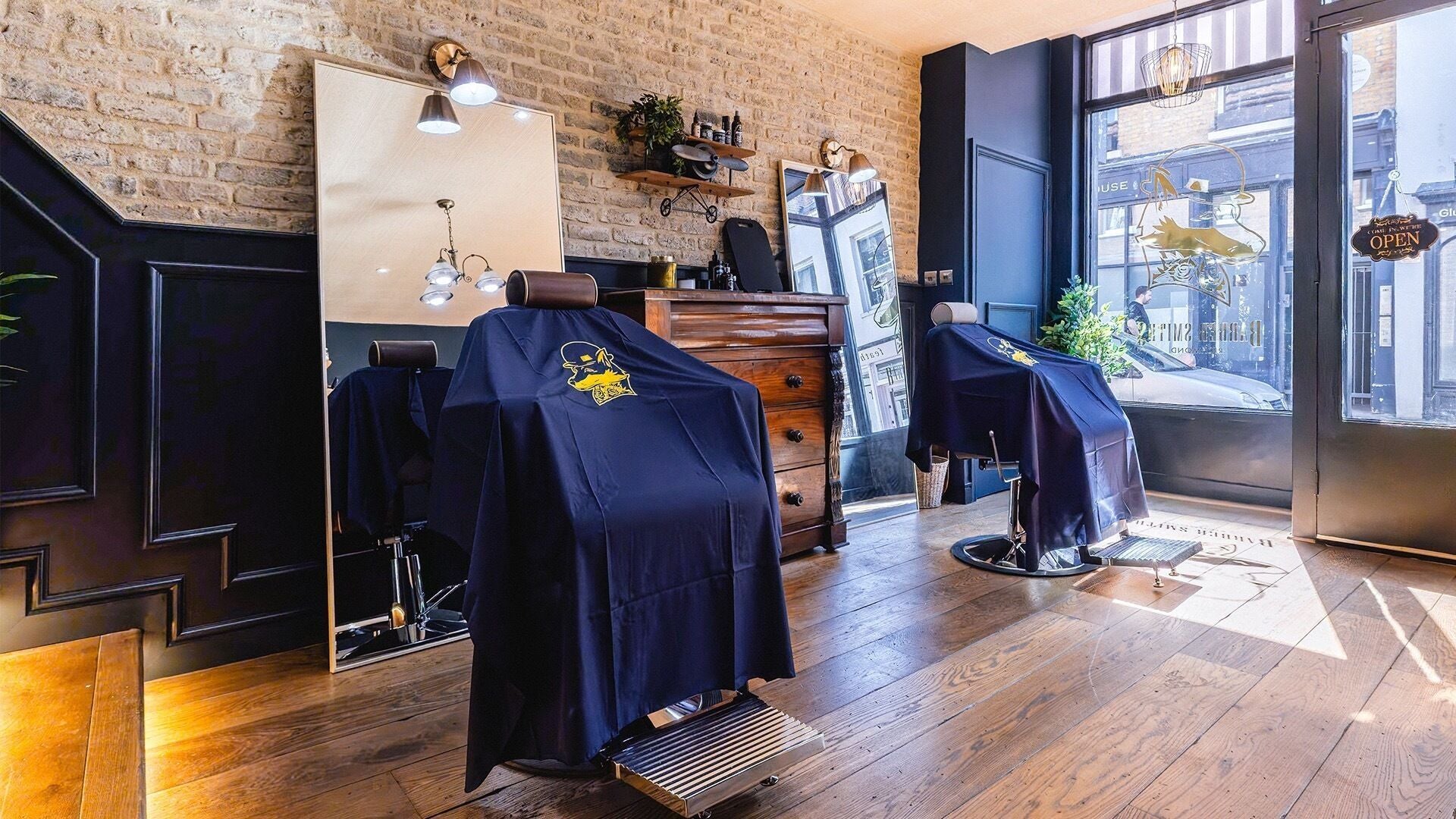 Chic interior of BarberSmiths Richmond, showcasing barber chairs and brick walls in Richmond, England, GB.