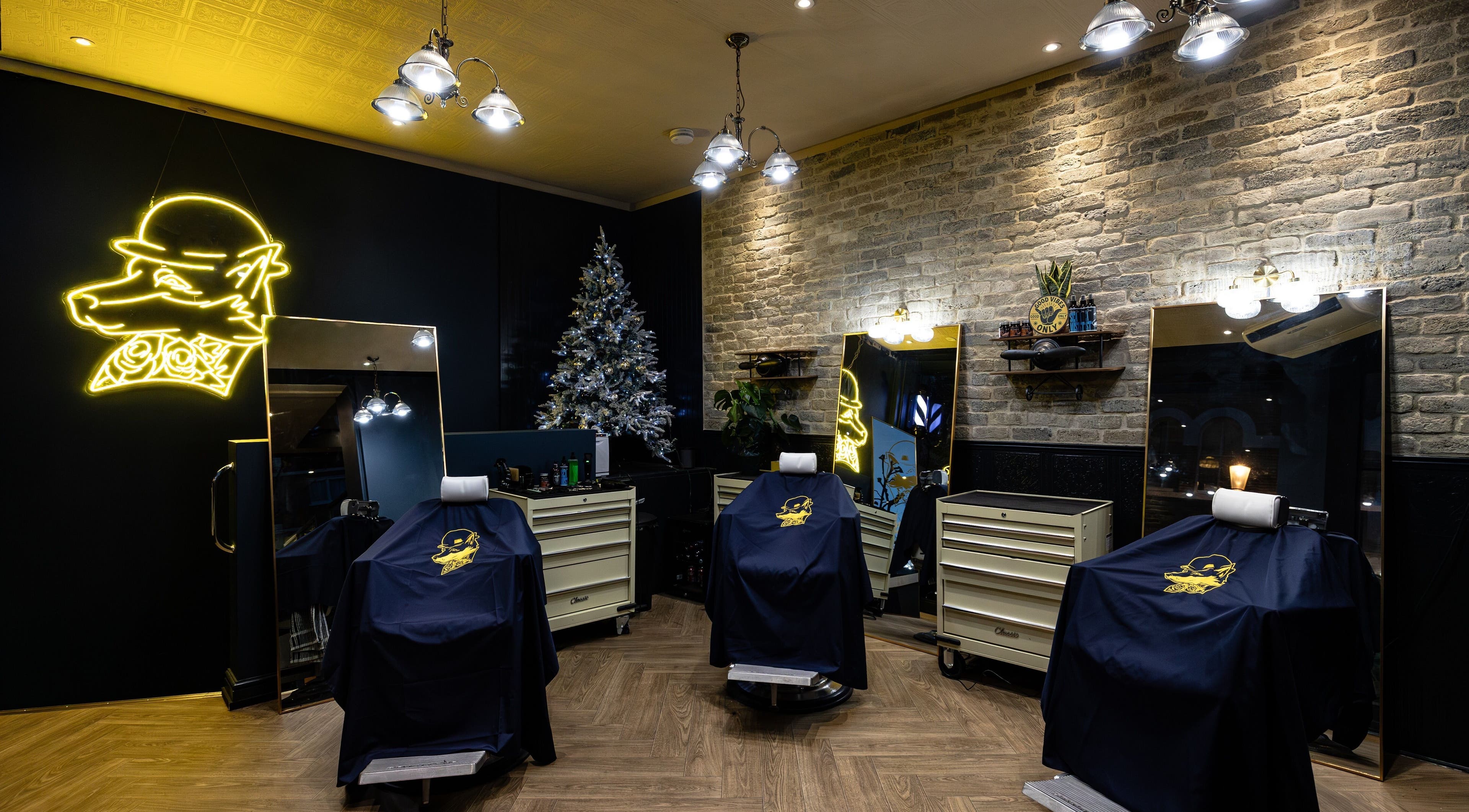 BarberSmiths Notting Hill interior with stylish chairs, London, England, GB. Neon light and festive decor visible.