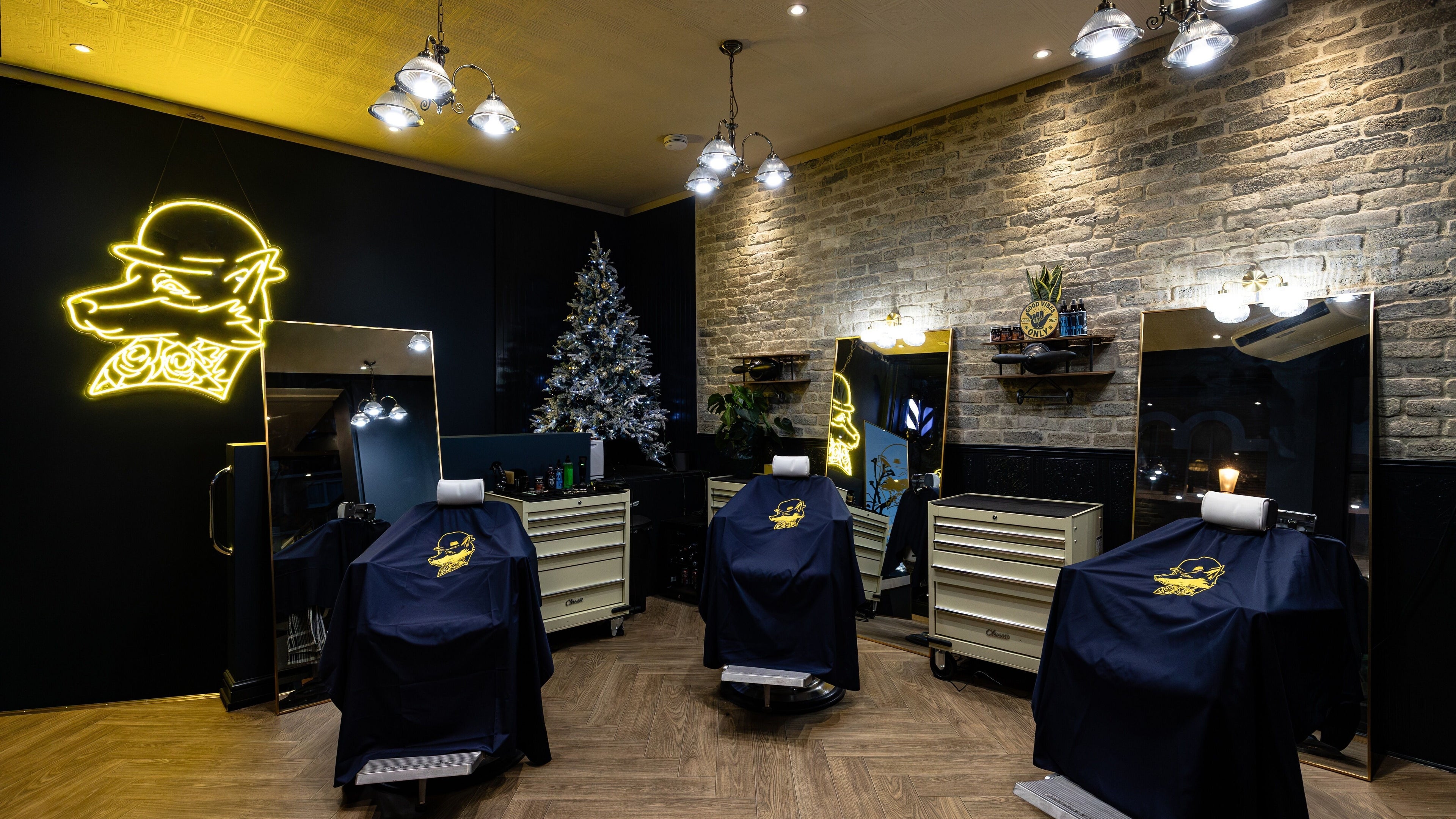 BarberSmiths Notting Hill interior with stylish chairs, London, England, GB. Neon light and festive decor visible.