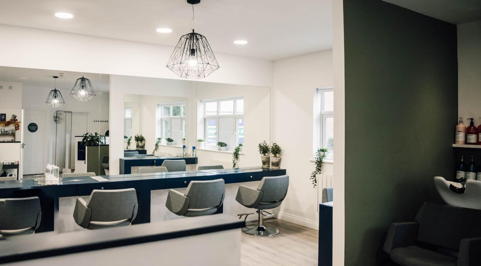 Modern interior of Sixty Three Hair Salon in Derby, England, GB, featuring sleek furnishings and stylish decor.