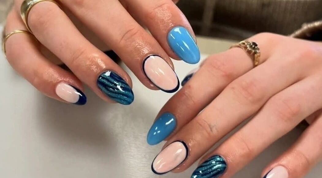 Vibrant nail art at The Professional Hair and Beauty Salon in Bingley, England, GB showcasing blue and white designs.