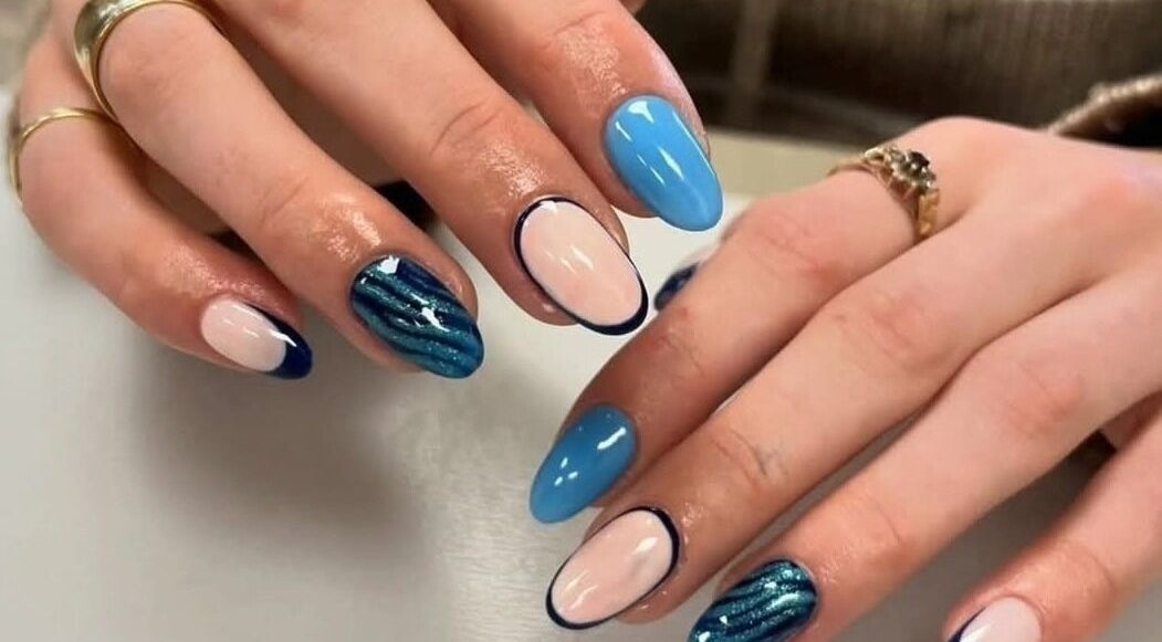 Vibrant nail art at The Professional Hair and Beauty Salon in Bingley, England, GB showcasing blue and white designs.