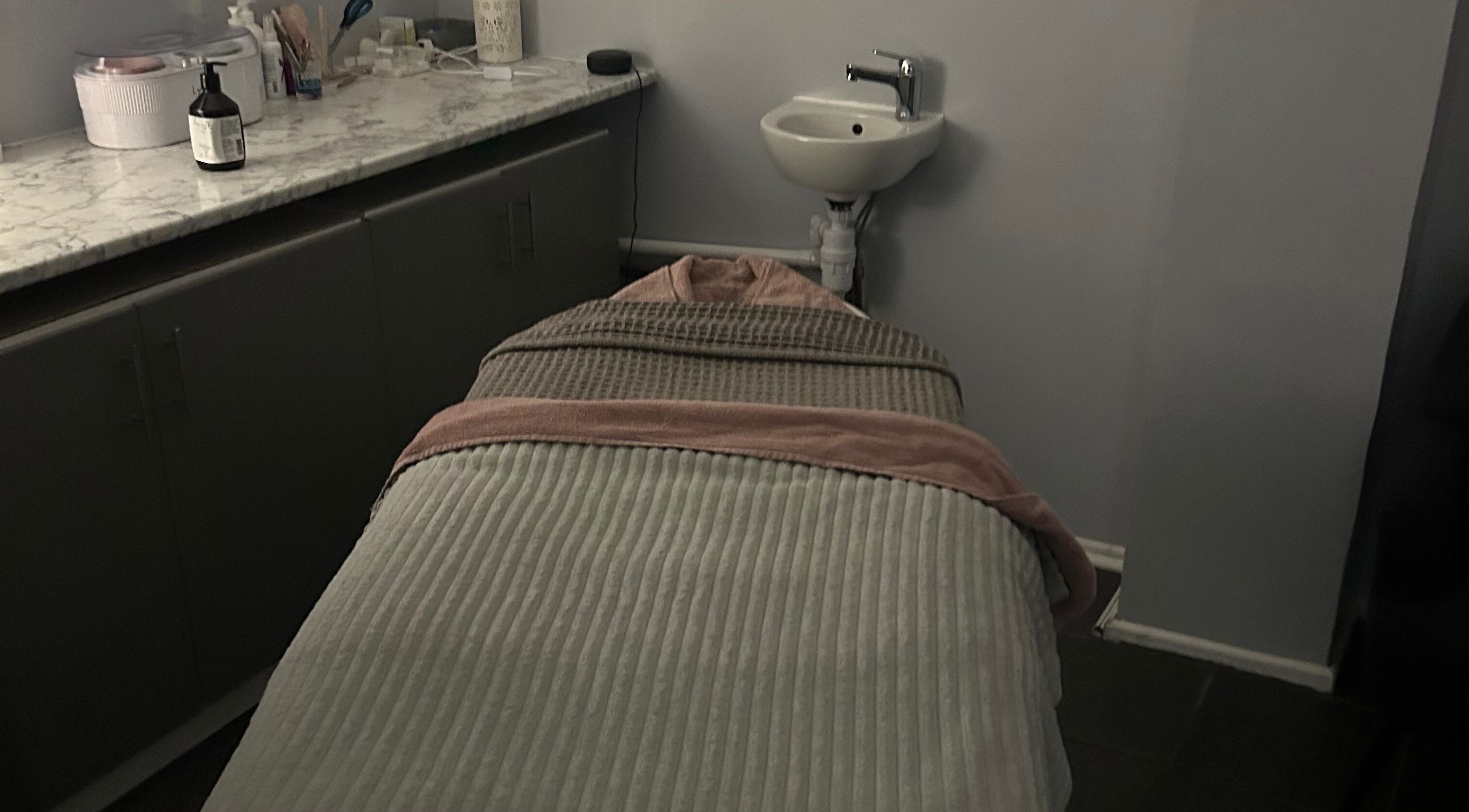 Blush Beauty Salon's serene massage room in Fleet, England, GB with a cozy treatment bed.