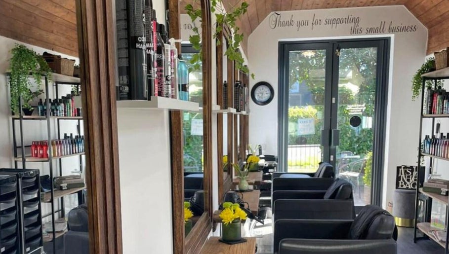 Interior of The Hair Exchange, Blunham, England, GB featuring modern decor and styling stations.