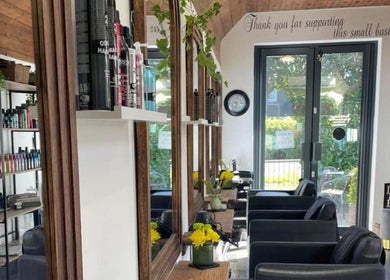 Interior of The Hair Exchange, Blunham, England, GB featuring modern decor and styling stations.