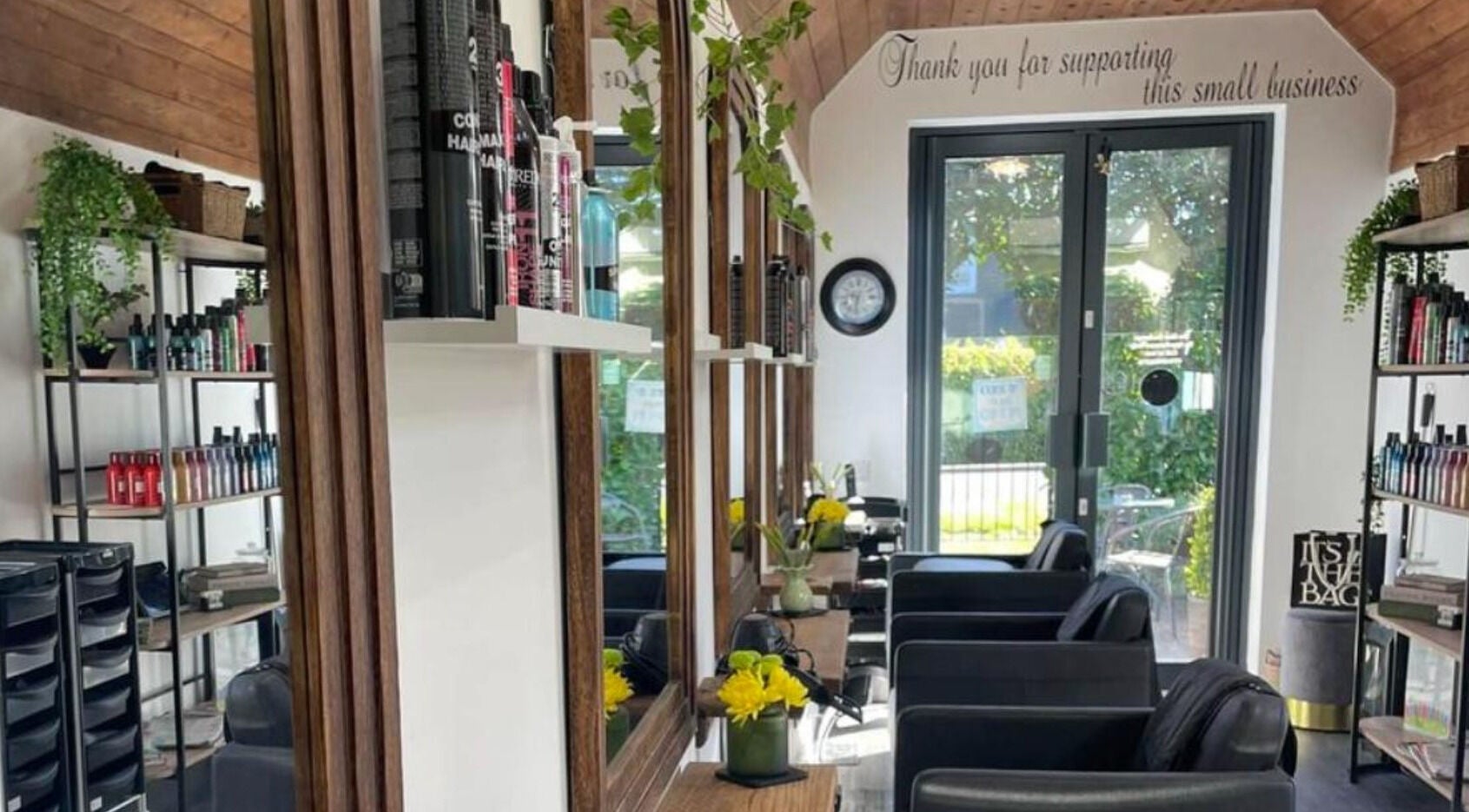 Interior of The Hair Exchange, Blunham, England, GB featuring modern decor and styling stations.