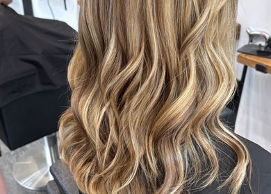 Stylish blonde wavy hair styled at The Hair Exchange, Blunham, England, GB.