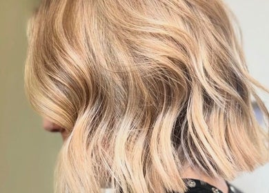 Blonde wavy hairstyle at The Hair Exchange in Blunham, England, GB, showcasing trendy salon expertise.