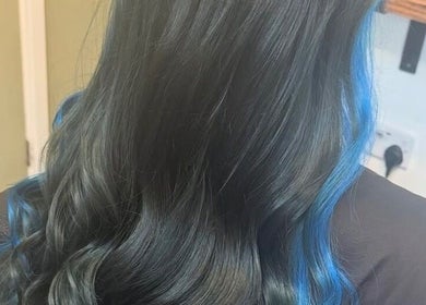 Elegant black hair with blue highlights at The Hair Exchange in Blunham, England, GB.