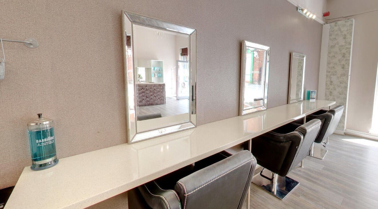 Chic styling area at Laura at Tailor Made Hair Extensions in Sedgley, England, GB with modern mirrors and chairs.